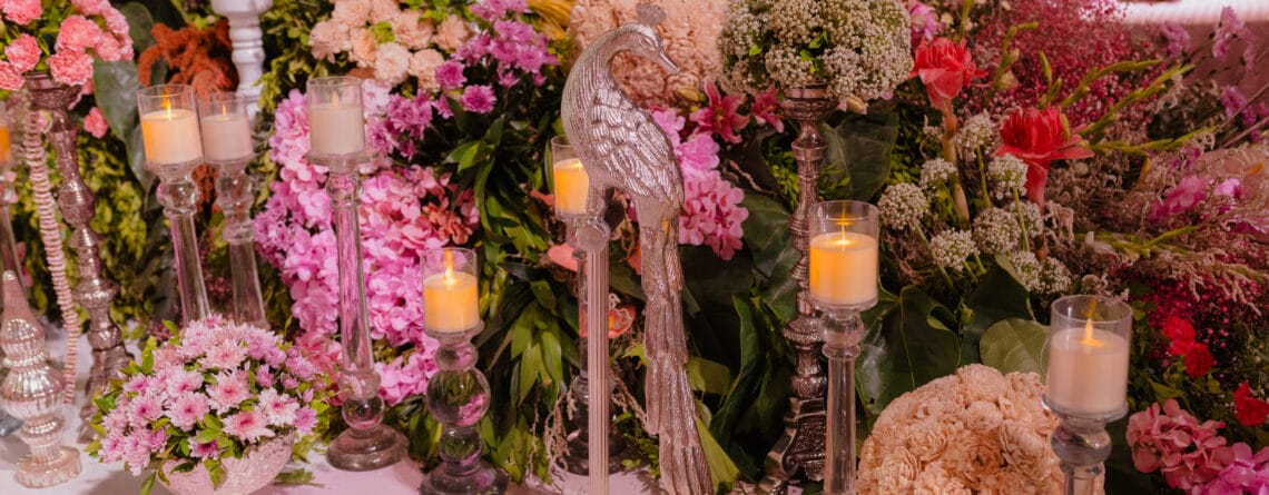 Barsana-style wedding celebration with marigold decor, traditional Indian folk elements, genda phool showers, dhol players, and guests participating in joyful rituals inspired by Radha-Krishna.